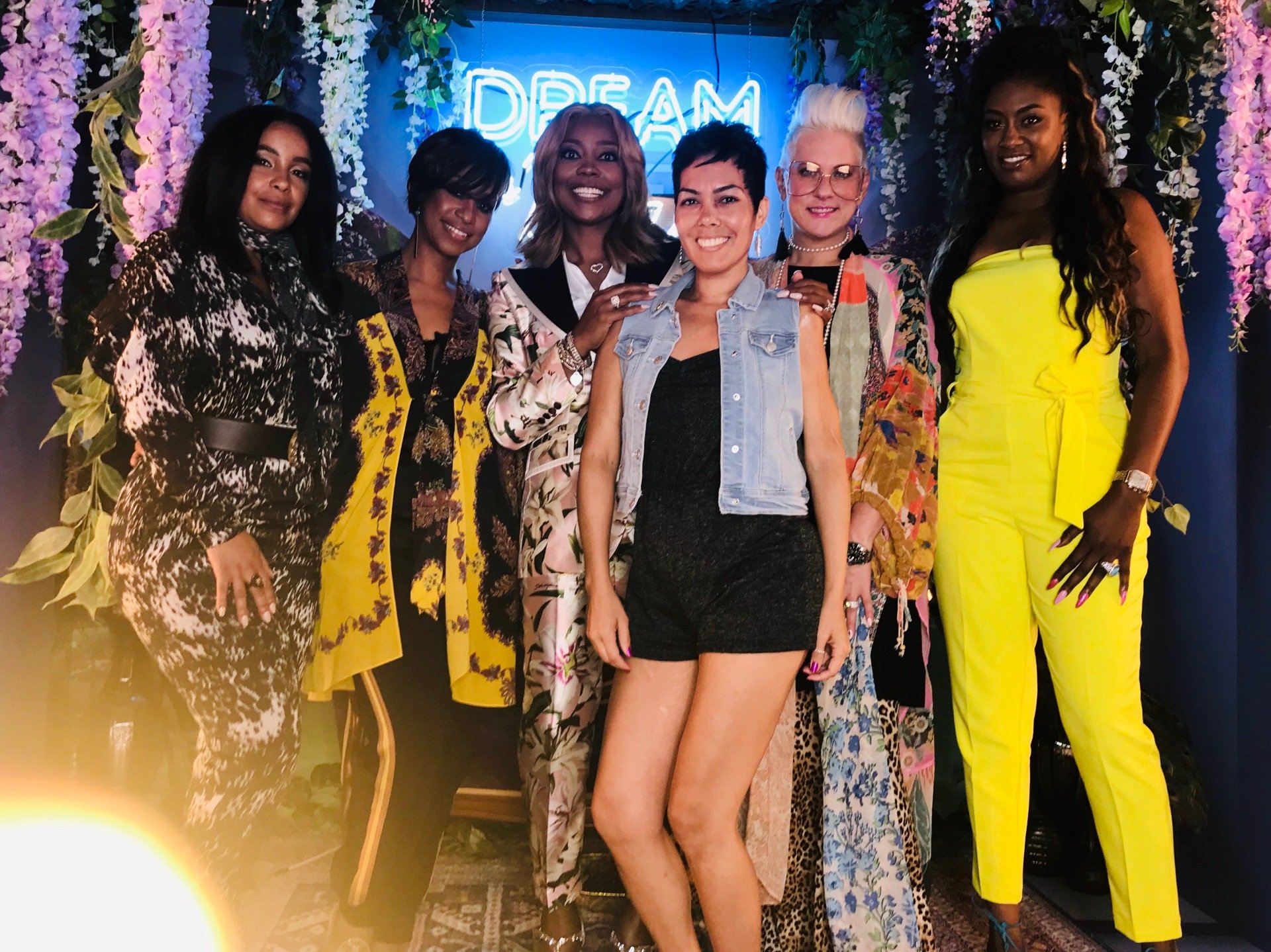 Dalila laughing with a group of friends at a community gala