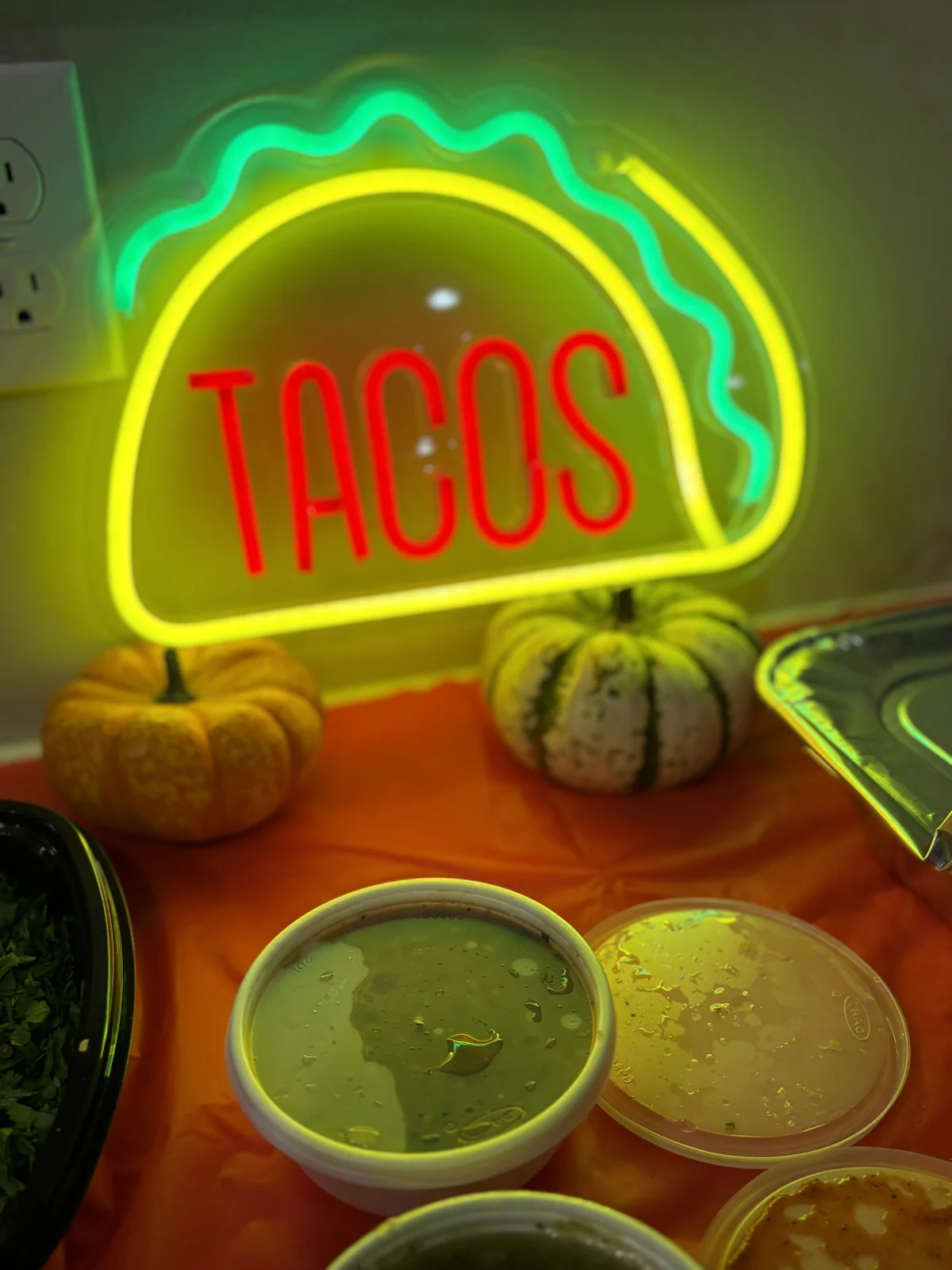 Glowing taco sign beside the salsa bar