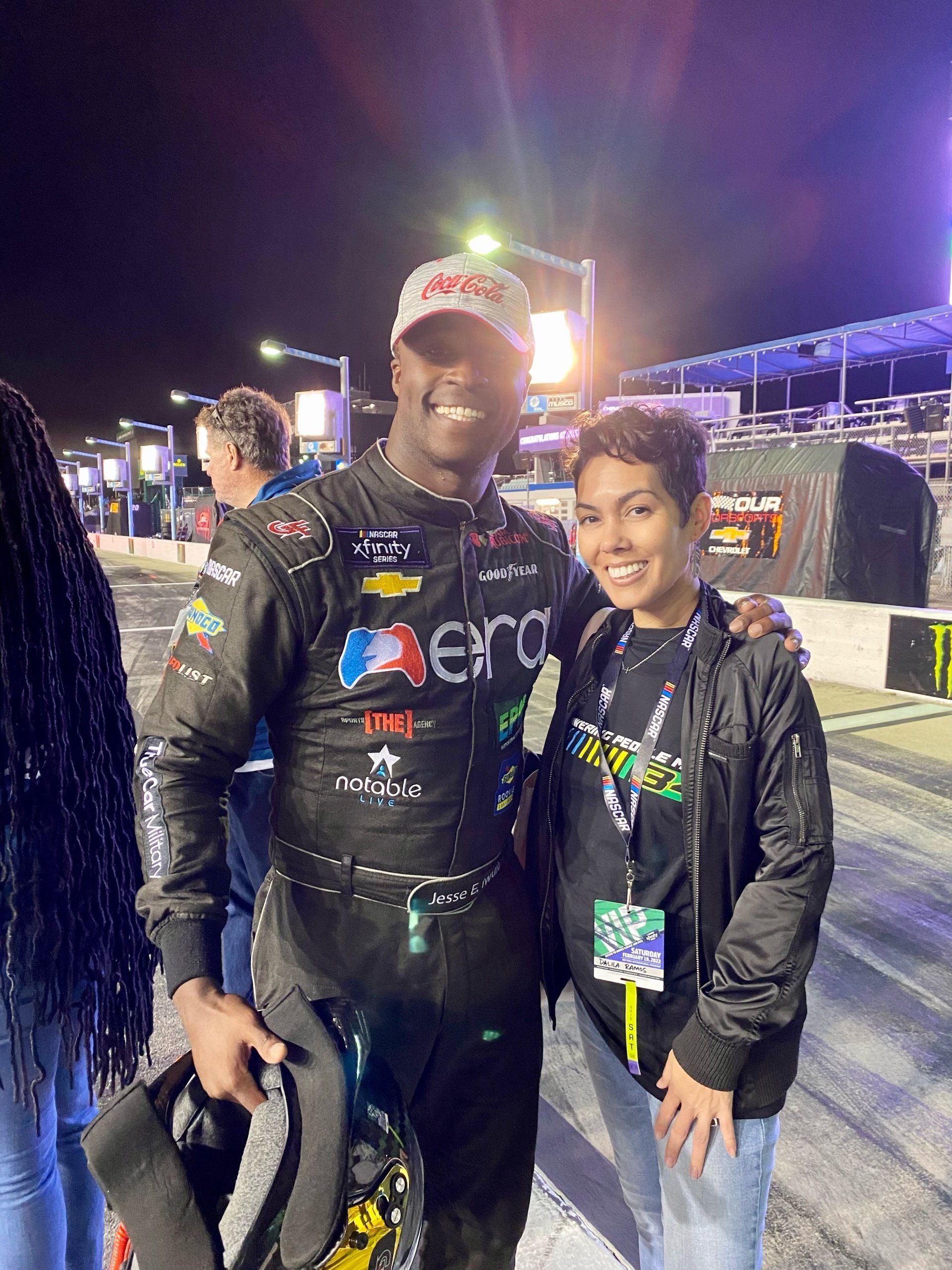 Dalila with a racing team member at an evening event