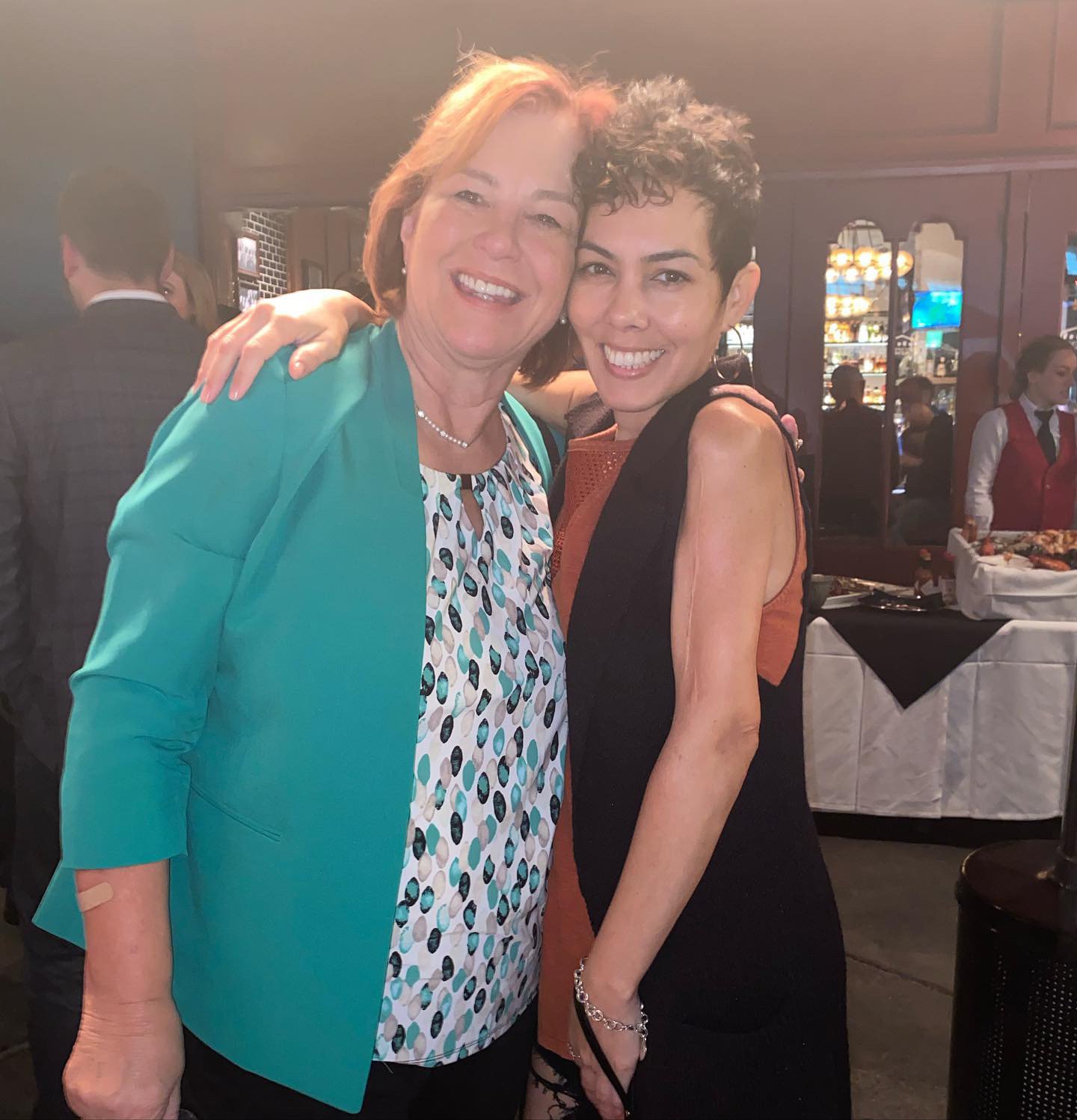 Dalila with a colleague at a dinner event